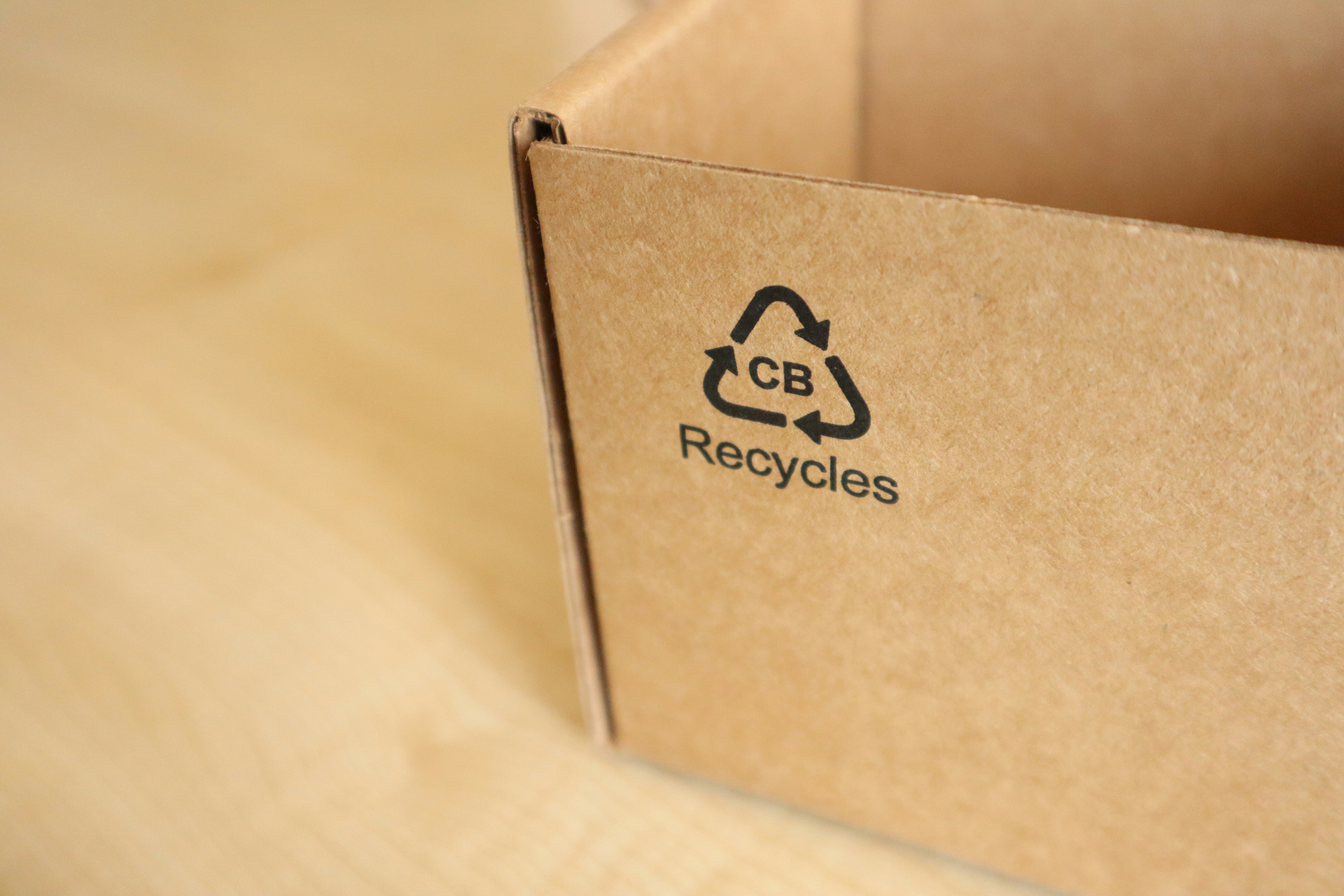 A cardboard box with a recycled logo on it